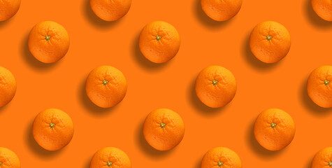Seamless pattern of citrus fruit - orange on orange background. Fresh repeating orange fruit on orange background