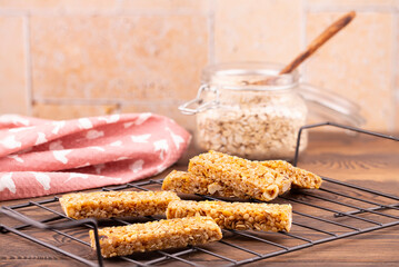 Cereal granola bar with nuts on a wooden table. Healthy sweet dessert snack