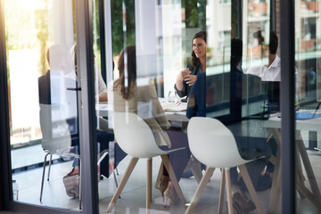 Meeting, boardroom and collaboration with a business team in a glass office for planning or...