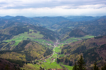 Obraz premium Stunning view of the small village of Böllen in a green valley from Mount Belchen in Black Forest (Schwarzwald), Germany