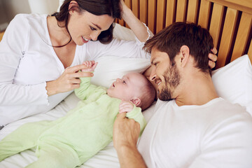 Top view of mother, father and baby in bedroom for love, care and quality time together at home. Happy parents, family and newborn kid relax on bed with support, childhood development and nurture