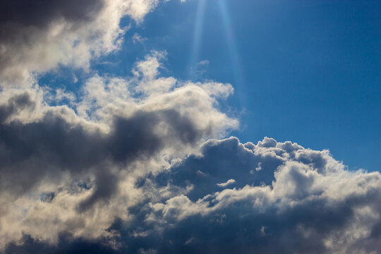 Clouds and a ray of sun. Symbol of divine light.