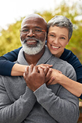 Portrait, park or senior couple with hug, interracial or romantic with bonding, marriage or relationship. Face, mature black man or elderly woman embrace, retirement or partners with romance or love