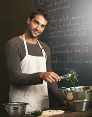 Chef, man and portrait with salad in kitchen for delicious meal, healthy diet and nutrition. Cooking, vegetables and male cook preparing vegan food for fine dining in restaurant or small business.