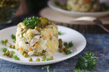 Olivier salad, traditional Russian dish, served on the plate	