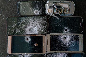 Phones shot with a gun, a lot of phones