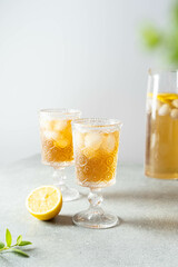 Black tea with ice and lemon in a tall glass. Cold lemonade. 