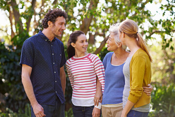 Happy family, parents with kid and grandmother in nature, happiness and freedom outdoor in park together. Love, trust and support with people spending quality time outside with care and generations