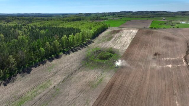 A drone view of the landscape of Warmia in the spring during field work, northern Poland, Europe