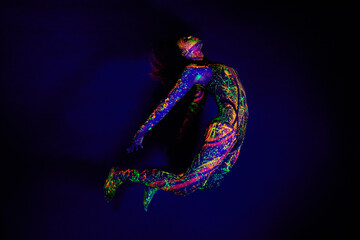 Woman, neon paint and dancer jump on dark background for creative performance, splatter texture and...