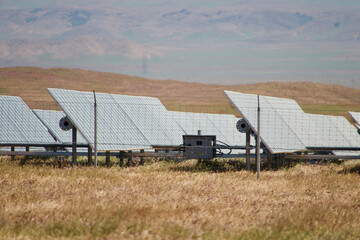 solar panels reflecting sunlight on a solar farm in the desert