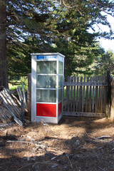 abandoned pay telephone booth on a parking lot