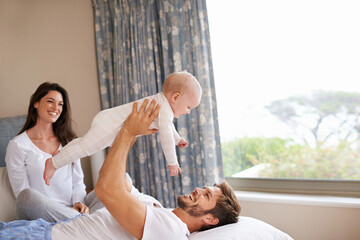 Happy family playing with baby in air, bedroom and fun of love, care and quality time to relax...