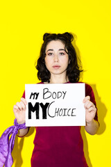 My body, my life, my choice. Studio shot of a serious attractive young latin woman holding placard...