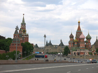 panorama of Red Square in Moscow: St. Basil's Cathedral, Spasskaya Tower of the Kremlin, tourist buses
