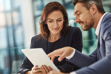 Tablet, meeting or planning with a business man and woman in the office for research on a company...