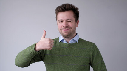 The European young man gives a thumbs up, approving the choice