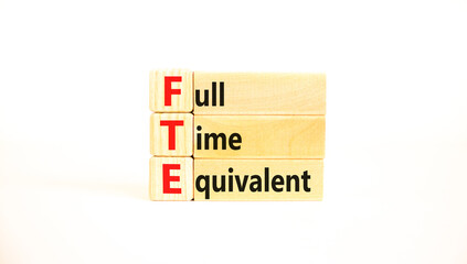 FTE Full time equivalent symbol. Concept words FTE Full time equivalent on wooden block. Beautiful...