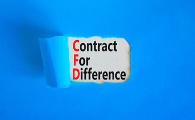 CFD symbol. Concept words CFD contract of difference on beautiful white paper. Beautiful blue table blue background. Business and CFD contract of difference concept. Copy space.