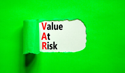 VAR Value at risk symbol. Concept words VAR Value at risk on beautiful white paper. Beautiful green table green background. Business and VAR Value at risk concept. Copy space.