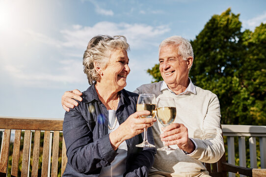 Love, cheers and wine glass, old couple in summer to celebrate romance or anniversary on patio of vacation home. Happiness, senior man and woman with champagne toast, smile and romantic on holiday.