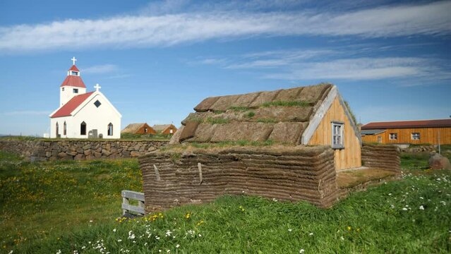 Icelandic church with a typical stone overgrown house covered with grasses in Iceland. Northeast Iceland around Fjallakaffi. High quality 4k footage. 