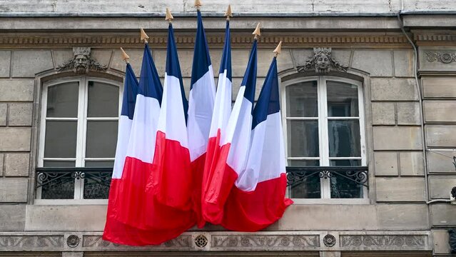 Flags of France on Elysee Palace, official residence of the President of Republic of France. French flags on building.