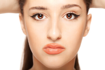 Fototapeta premium Beautiful girl close up studio portrait against white background.