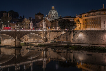 Fototapeta na wymiar Scenic night cityscape of Rome with the illuminated cupola of St. Peter Basilica, Italy