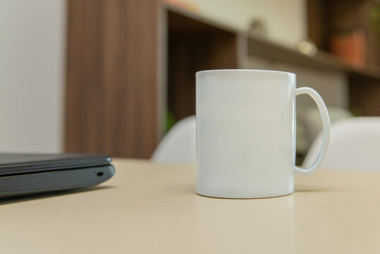 Caneca / xícara branca em mesa de escritório
