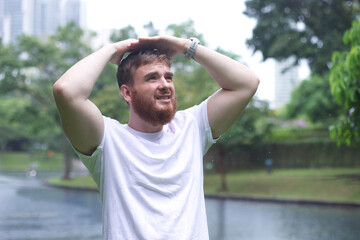 Sad man under summer rain.emotional guy wet in the rain without umbrella walk in the rain.young...