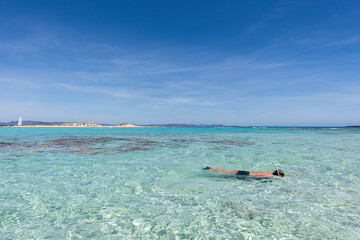 Man snorkelling in clear, turquoise water off the islet of s'Espalmador, in Formentera (Balearic Islands, Spain)