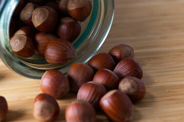 handful of hazelnuts on wooden bowl and wooden table, very healthy nuts