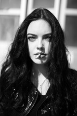 Black and white shot portrait of beautiful girl with cigarette in her lips