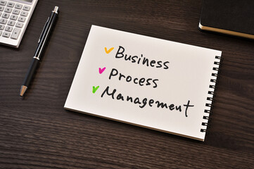 There is notebook with the word Business Process Management.It is as an eye-catching image.