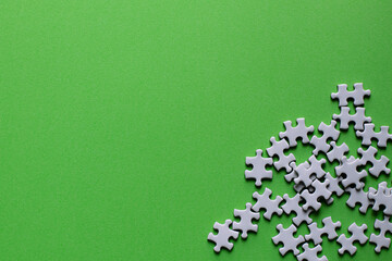Green background with pieces of puzzle.
