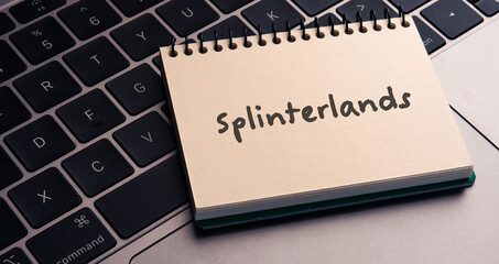 There is notebook with the word Splinterlands.It is as an eye-catching image.