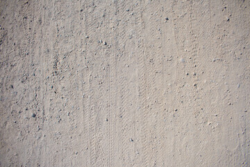 Natural sandy stone texture background. Sand texture of sandpile. Features of steps and Bicycle over white sand. Background.