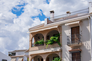 Village Houses in Córdoba, Andalusia, Spain. Village houses adorned with plants and a clear blue sky.