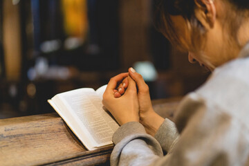 Christian woman reading bible in an ancient Catholic temple. Reading the Holy Bible in temple....