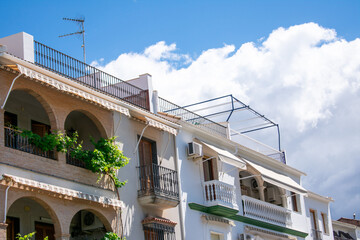 Village Houses in Córdoba, Andalusia, Spain. Village houses adorned with plants and a clear blue sky.