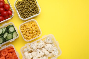 Plastic and glass containers with different fresh products on yellow background, flat lay. Space for text