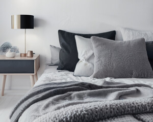 A high-resolution photorealistic close-up illustration of a Scandinavian style bedroom with comfortable bed, pillows and blanket | Interior design of a modern and luxurious bedroom | Generative Ai
