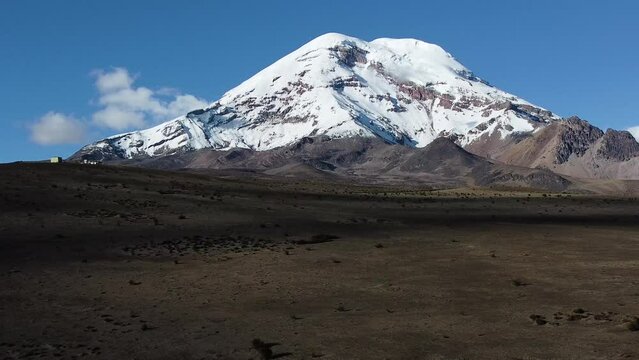 Chimborazo volcano with snow on the slopes and peak  visible on a clear day with blue skies Aerial Video