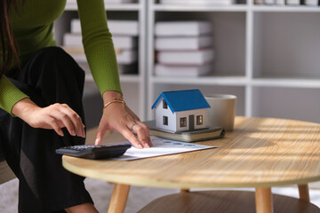 Renter or homeowner using calculator, and planning budget manage household expenses paperwork.