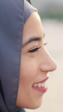 Image with copy space of a serious muslim woman starting to smile