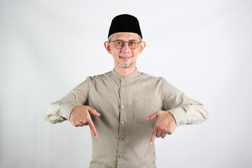 Portrait of Asian Moslem Man pointing down, explain something

