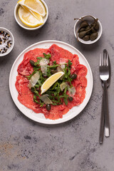 Marbled beef carpaccio with arugula, capers, lemon and parmesan cheese