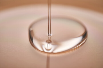 A juicy drop of gel on a beige background.
