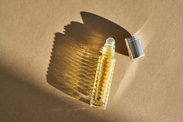Oil roller perfume on a beige background.